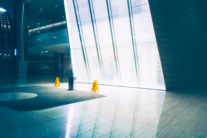 Polished commercial floor with professional cleaning equipment in background